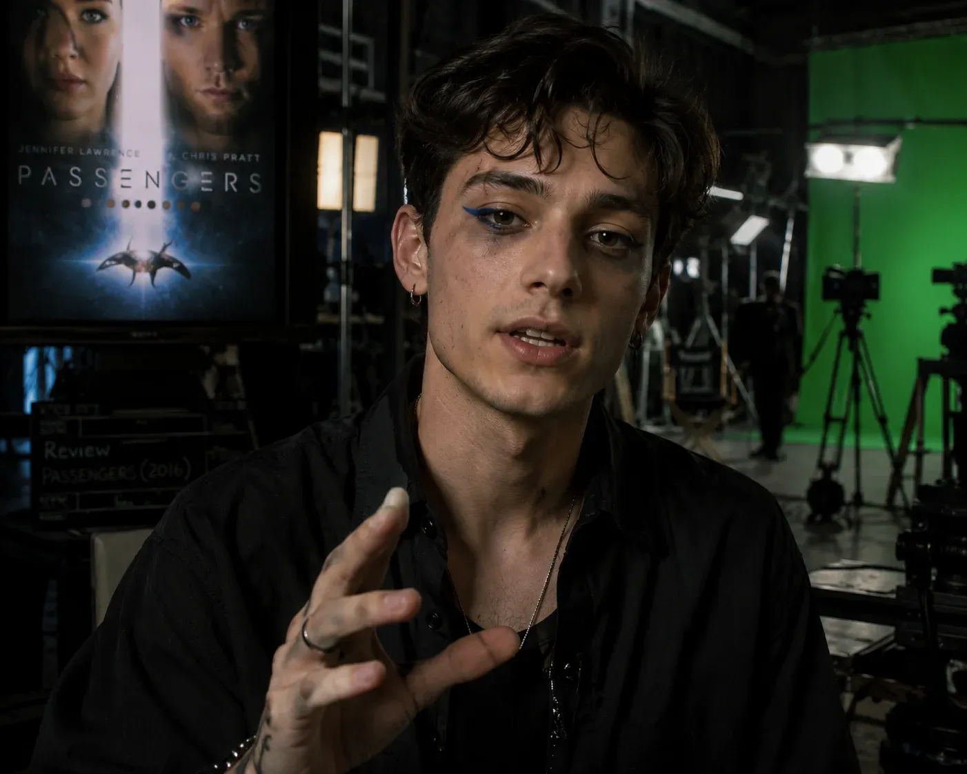 Photoreal candid portrait of a young man with messy hair and smudged dark eye makeup gesturing on a film set, a Passengers movie poster on the wall and a green screen with light stands behind him