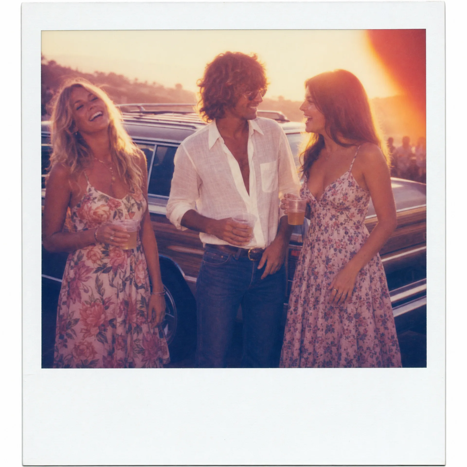 Polaroid 600 instant film photo of three friends at a 1972 California summer party at sunset, warm color cast, soft focus, pure white Polaroid frame, Andy Warhol Big Shot spirit