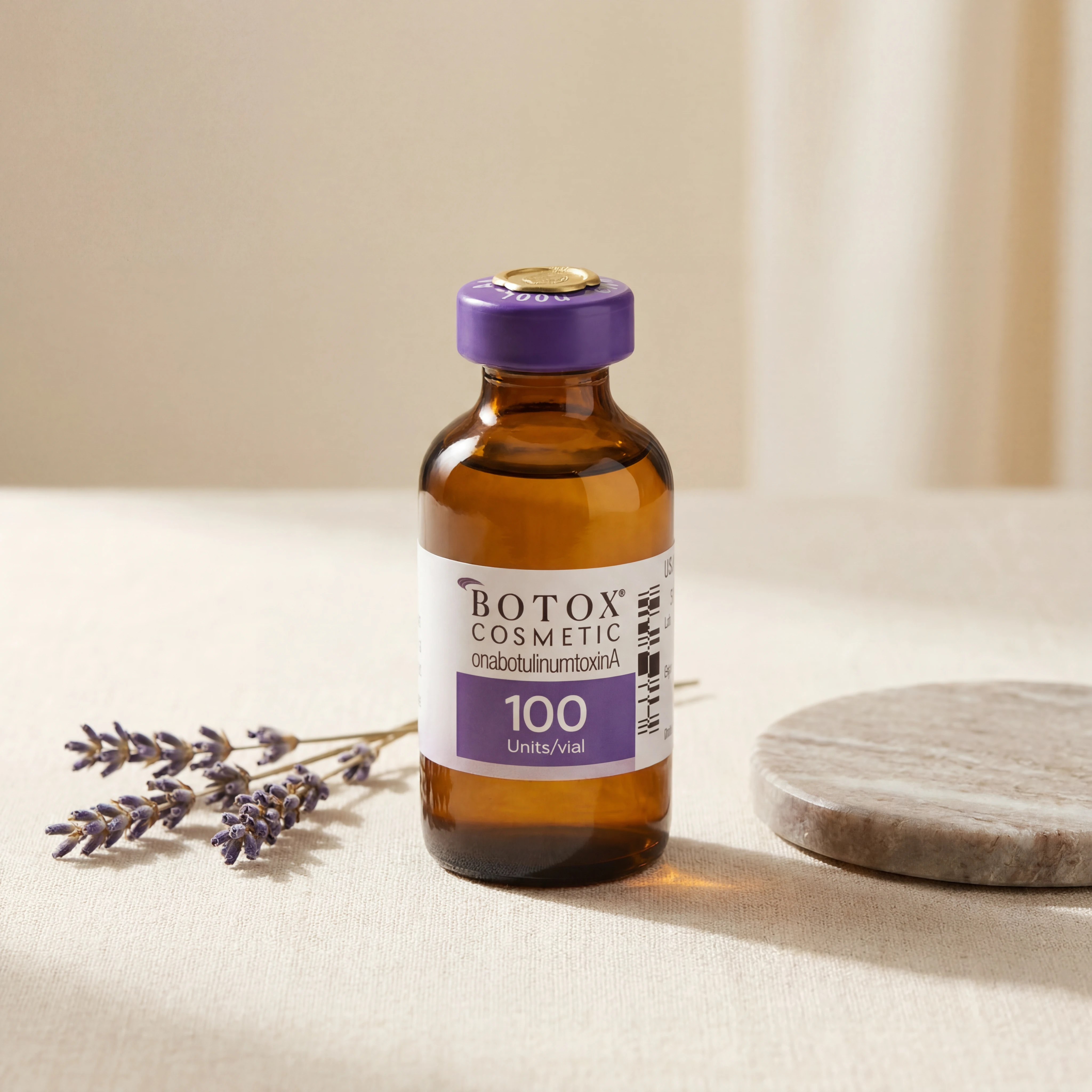Hyperrealistic luxury product photography of a Botox Cosmetic onabotulinumtoxinA vial with purple cap and brand label standing upright on warm cream linen surface next to a sprig of dried lavender and a round flat marble coaster, softly diffused warm cream studio background with natural window light, editorial luxury skincare brand aesthetic